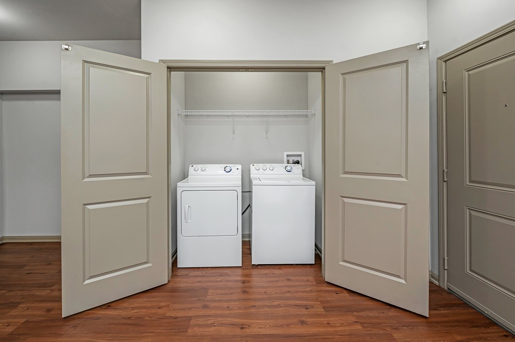 Two washing machines are in a laundry room.